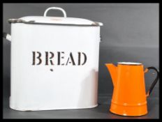 A vintage 20th centurty white metal painted enamel bread bin with notation and lid together with a
