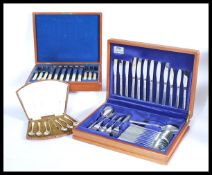 Two vintage 20th Century oak cased canteens of silver plated cutlery, one being a fish service.
