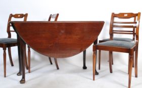 A 19th century Georgian mahogany drop leaf dining table being raised on turned legs with pad feet.