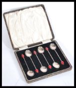A set of 6 silver hallmarked coffee bean spoons with red bean handles. Complete in the