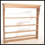 A 19th century Victorian hanging pine wall shelf / plate rack having multiple shelves with flared