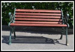 A very heavy 20th century cast metal garden bench, recently having new wooden slats added and a
