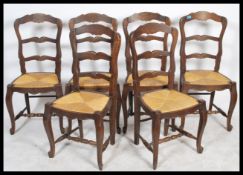 A set of 6 French provincial oak ladderback dining