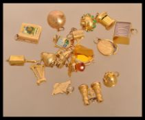 A good group of 9ct gold bracelet charms to include a bowling ball , 10 Shilling note , Boot house ,
