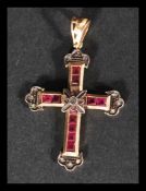An Italian 14ct gold ruby and diamond crucifix pendant being set with 10 square cut rubies of approx