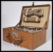 A vintage early 20th century gents vanity case fully appointed with silver white metal topped