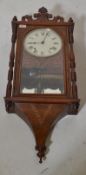 A 19th century Victorian mahogany and boxwood inlay wall clock having hard carved pediment with