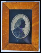 A 19th century Georgian portrait miniature silhouette picture of a gent in wig having gilt