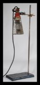A vintage 20th Century Industrial inspection lamp suspended from an early 20th Century George and