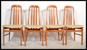 A 1970's retro set of teak wood railed back dining chairs having pad seats with shaped legs united
