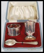 A silver hallmarked three piece Christening set consisting of a napkin ring , egg cup and a small