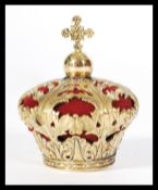A brass pincushion in the form of a crown with acanthus leaf decoration.