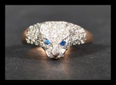 A hallmarked 9ct gold ring in the form of a panther set with blue stone eyes and pave white