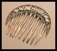 A sterling silver and marcasite art deco hear clip set with CZ stones. Weighs 14 grams.