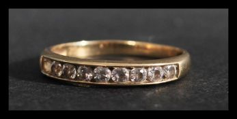 A hallmarked 9ct gold 8 stone ring set with 8 channel set white stones. Hallmarked Birmingham.