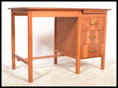A retro mid century teak wood pedestal desk. Raised on squared legs with open kneehole recess