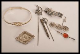 A group of sterling silver jewellery to include a Celtic knot bangle , horse shoe and riding crop