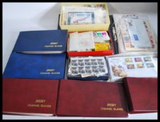A large quantity of stamps and first day covers FDS in albums to include many Jersey examples.