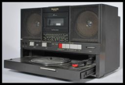 A retro 20th Century Panasonic portable record player, tape player and radio combo