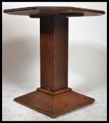 An early 1920's oak Art Deco centre / occasional table, octagonal top raised on a square support