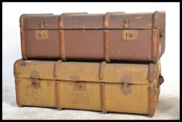 Two vintage 20th Century canvas and cane bound steamer trunks, both fitted with locks and latches to