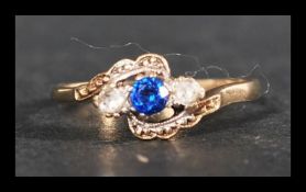 A hallmarked 9ct gold three stone ring set with a central blue stone flanked by two white stones