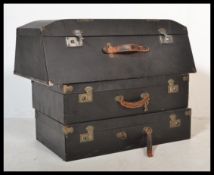 A pair of vintage early 20th Century ebonised suitcases together with a stunning angular ebonised