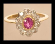 An 18ct gold ruby and diamonds flower head ring of approx 2cts. Size O weighs 3.9 grams.