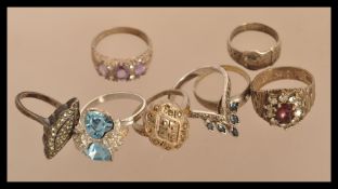 A group of vintage silver white metal rings to include a hallmarked bark effect ring , hallmarked