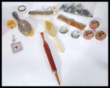 A collection of antique and vintage curios to include silver hallmarked dressing table brushes,