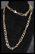 A hallmarked 9ct tri gold Figaro chain necklace having a lobster claw clasp. Measures 19 inches.