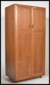 A stunning light beech and elm wood Ercol two door ' Windsor pattern ' wardrobe, fitted with twin