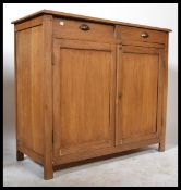 An early 20th Century Elm Buffet having two drawers over two panel doors...