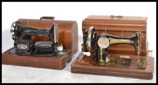 2 early 20th century sewing machines by Singer. Both with the original carry cases of mahogany