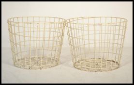 A pair of vintage 20th century  industrial metal wire baskets of cylindrical tapering form.
