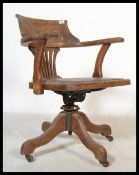 An early 20th century Industrial office swivel chair / desk armchair being raised on quadruped