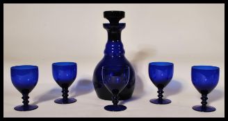 A 20th Century blue glass decanter and stopper in the manner of Bristol Blue Glass together with