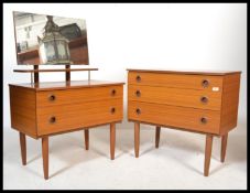A retro mid century teak wood chest of drawers and matching dressing table being raised on