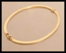 A sterling silver gilt bangle of typical form having hidden clip clasp. Weighs 6 grams.