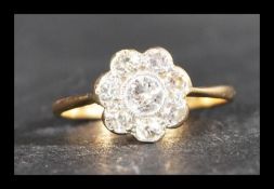 An 18ct gold platinum and diamond cluster ring having a central diamond of approx 20pts surrounded