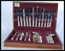 A 20th century cased canteen of cutlery being fully appointed and complete set to a baize lined