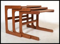 A vintage retro 20th century Danish influence set of teak cantilever coffee tables in the manner