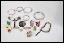 A group of silver bangles along with a rolled gold example and a small group of silver jewellery.