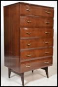 A retro mid century lacquered chest of drawers and dressing table having decorative handles and