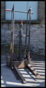 A pair of vintage / retro 20th Century industrial metal tubular forked sack trucks fitted with a