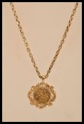 A 1910 gold half sovereign in a hallmarked 9ct gold floral and leaf mount with a 9ct gold necklace