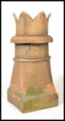 An early 20th century stoneware chimney top having a wavey castle top on cylindrical tapering body