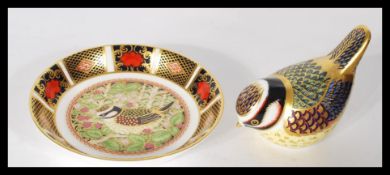 A Royal Crown Derby paperweight in the form of a blue tit with gold stopper and the matching tray
