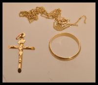 A hallmarked 9ct gold band ring along with a 9ct gold crucifix cross pendant and a 9ct gold chain