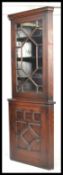 A good quality Edwardian oak Astragal glazed double free standing corner cabinet with panelled